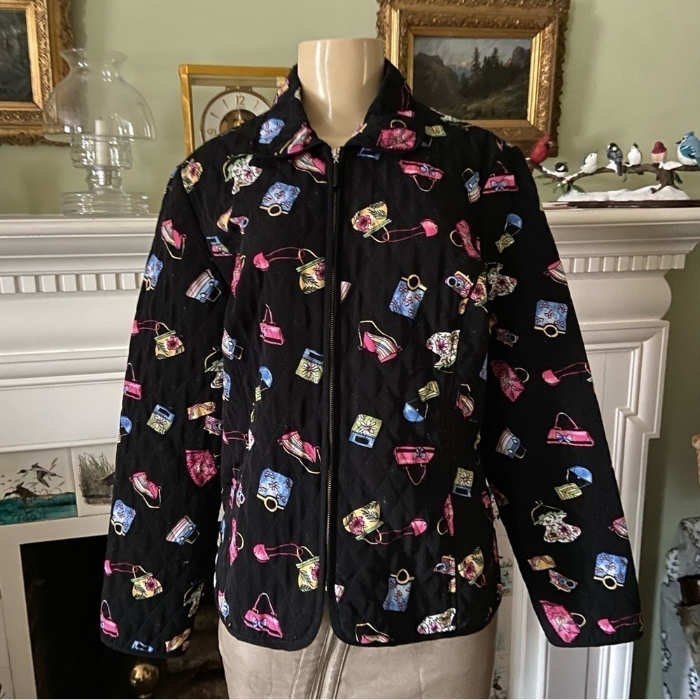 Quilted jacket by requirements with purses galore all over on a field of black.
